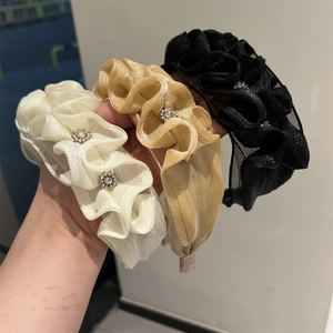 Detailed set of three organza headbands in white, champagne gold, and black with rhinestones