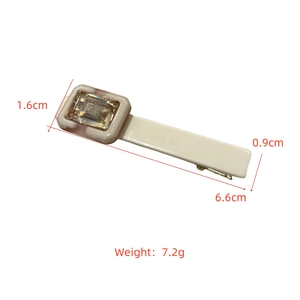 Detail view of acetate hair clip with champagne rhinestone showing dimensions 6.6cm by 0.9cm
