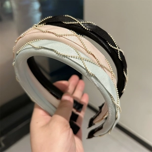 Detail view of woven satin headbands with golden bead chain mesh in three colors