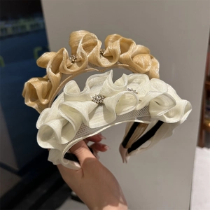 Detailed texture of champagne and white organza headbands with sparkling rhinestones