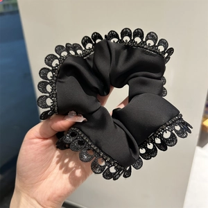 Elegant black lace hair scrunchie with satin texture and embroidered flower border