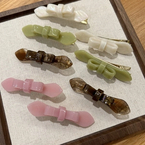 Chic double-layered acetate bow hair clips in multiple colors with elegant marble finish