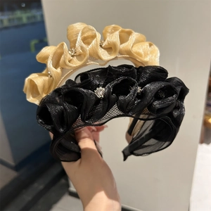Detailed macro of pleated organza headband featuring sparkling small rhinestone accents