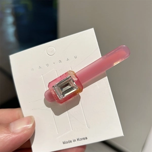 Elegant pink acetate hair clip with large rectangular rhinestone on display card