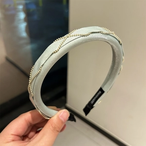 Elegant light green satin headband featuring intricate gold beaded chain link decoration