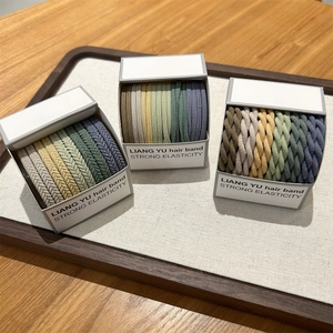 Elastic woven hair bands in Morandi colors shown on a wooden tray with a 45-degree angle