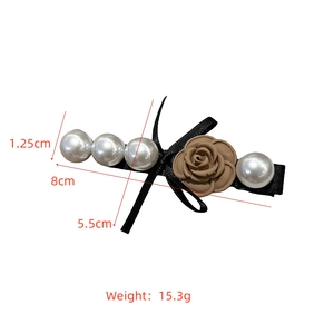 Detailed view of hair clip with dimensions 8cm showing pearls, rose and bow details