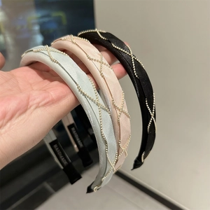 Three elegant handmade braided hairbands in black, pink, and blue with gold chain details