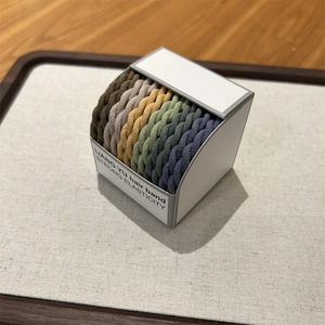 Detail of twisted woven hair bands in Morandi colors with high elasticity texture