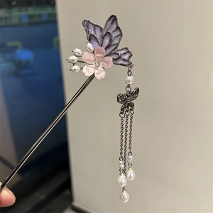 Detail of elegant butterfly hair pin with purple enamel, pink flower and pearl tassels