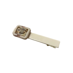 Elegant cream acetate hair clip featuring a rectangular amber gemstone and gold metal base