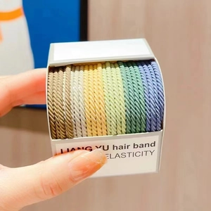 Close-up of spiral elastic hair bands in colorful gradient set with durable woven texture
