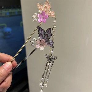Detailed close-up of butterfly tassel hairpins with purple flowers and pearl accents