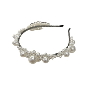 Elegant wide floral headband with white imitation pearls on a slim dark gray metal base