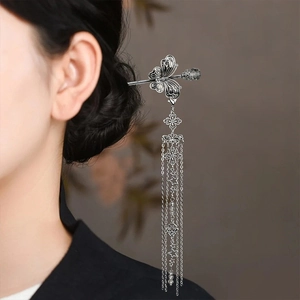 Close-up of butterfly hair pin with long tassels and beads for traditional styling