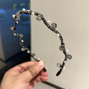 Detail of handmade headband featuring faceted grey crystals and round white pearls