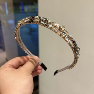 Detail of double-layer headband with crystal zircons and grey fabric-wrapped band