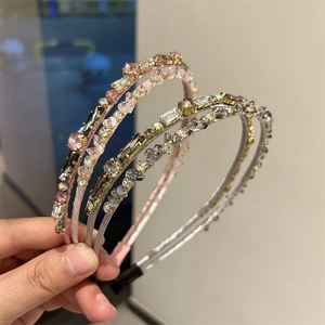 Detail of four crystal headbands in pink and grey showing multifaceted rhinestones
