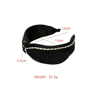 Detail view of black satin headband with white lace trim showing size 15cm by 13cm