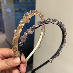 Dettaglio di cerchietti fatti a mano con pietre di cristallo viola e rosa e perline
