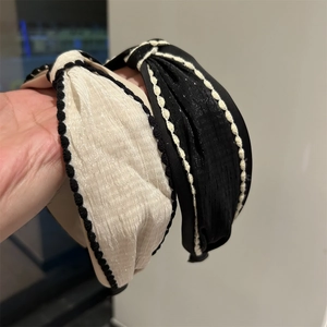 Minimalist knotted fabric headbands in cream and black with contrast crochet edges
