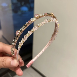 Detailed view of handmade crystal headbands with champagne and pink rhinestones
