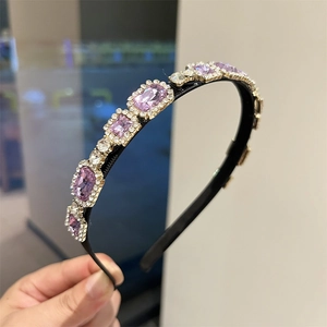 Close-up of elegant purple crystals and fine white rhinestones on a slim headband