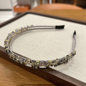 Close-up of crystal zircon headband with grey satin fabric and soft silicone tips