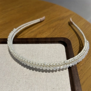 Detailed close-up of handmade double-row headband with ivory pearls and crystal beads