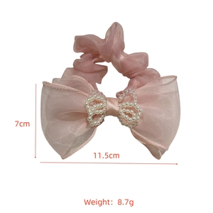 Pink mesh scrunchie with layered bow and pearl center detailing, sized 11.5cm by 7cm