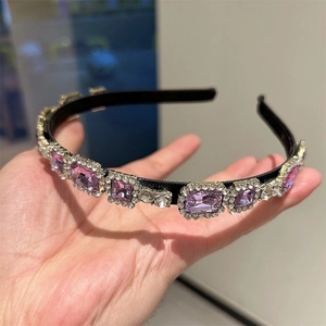 Detail view of vintage French rhinestone headband with purple and clear gems