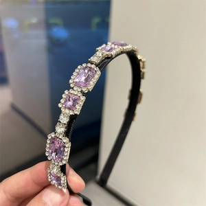 French style headband with purple rectangle crystals and round rhinestones in a hand view