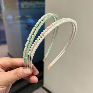Detail of beaded headbands with mint green crystals and white pearls on slim metal wire