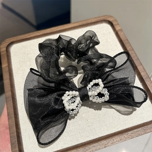 Elegant black mesh bow scrunchie with pearl heart accents and subtle glitter finish