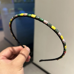 Detail of colorful rectangular crystal beads hand-wrapped on a slim headband