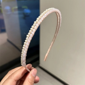 Close-up of double-layered headband featuring faux pearls and pink faceted crystal beads