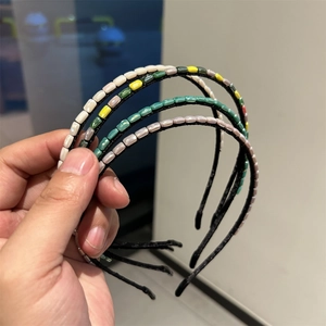 Detail of colorful beaded hairbands with handcrafted rectangular beads in various colors