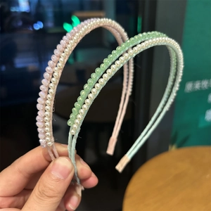 Detail of pink and green beaded headbands with white pearls and faceted crystals