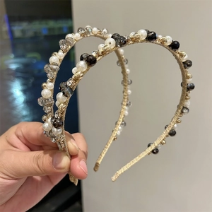 Close-up of handmade retro hairband featuring ivory pearls and faceted crystal beads