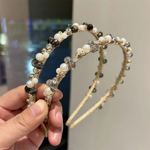 Detail of vintage handmade headbands with faux pearls and crystals on gold woven bands