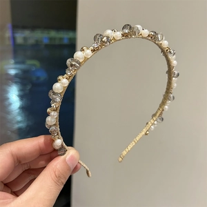 Elegant gold headband with white pearls and dark grey crystals for women's hair styling