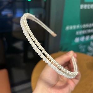 Detail of double-layer headband featuring faux pearls and clear faceted crystal beads