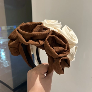 Handmade rose fabric headband in brown and beige colors with a vintage elegant design