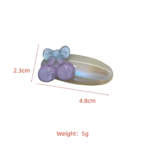 Detailed view of handmade acetate cherry hair clip with dimensions 4.8cm by 2.3cm