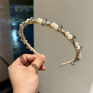 Detail of handmade headband featuring crystal beads and faux pearls on a gold wire