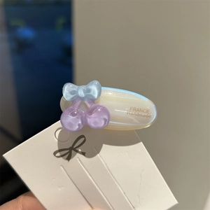 Macro view of pearlescent acetate hair clip with cute pastel resin butterfly details