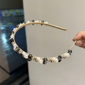 Detailed macro view of handmade gold wire headband with vintage crystals and pearls