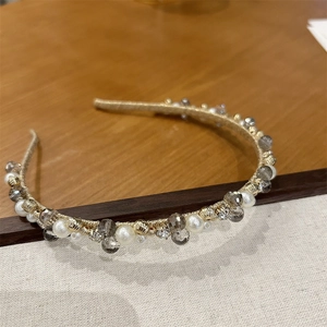 Detailed view of handmade gold wire headband with elegant pearls and crystal beads