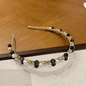 Detailed close-up of handmade vintage headband with crystal beads and white pearls
