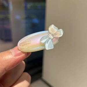 Detail of acetate oval hair clip with bow and France Handmade logo engraving